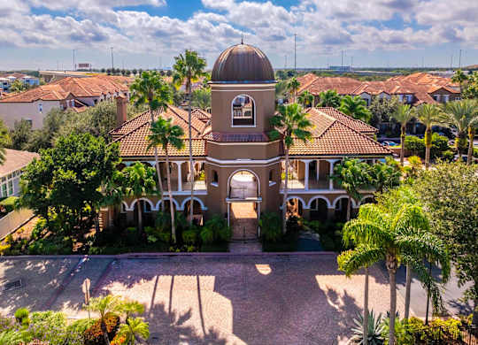 Iconic domed clubhouse surrounded by palm trees and Mediterranean architecture