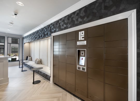 the mail center with package lockers and a bench for seating