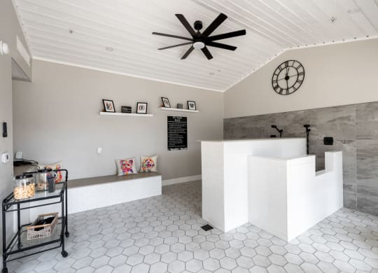 a large white reception desk with a large clock on the wall