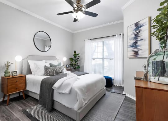 Mesa Verde Bedrooms Bright and Spacious Bedroom with Wood Look Vinyl Flooring Ceiling Fan and Crown Molding