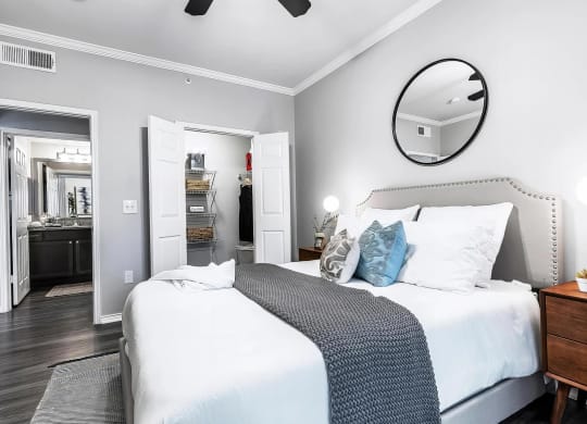Mesa Verde Bedrooms Bright and Spacious Bedroom with Wood Look Vinyl Flooring Ceiling Fan Crown Molding and Closet with Built in Shelving