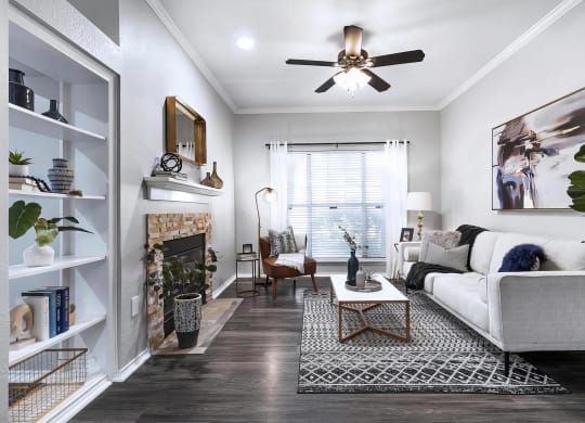 Mesa Verde Rooms Living Room with Wood Look Vinyl Flooring Fireplace Built In Shelves and Ceiling Fan