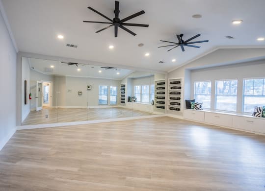 a large living room with a hardwood floor and a ceiling fan