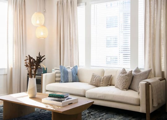 Cozy living room with giant windows and modern finishes at Novel Cary