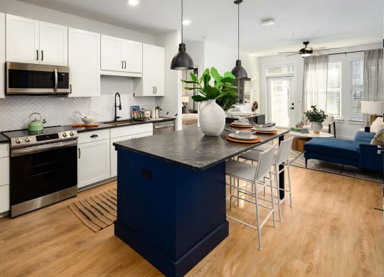 Modern kitchen area with wood-style floors and tall ceilings at Harpeth Heights