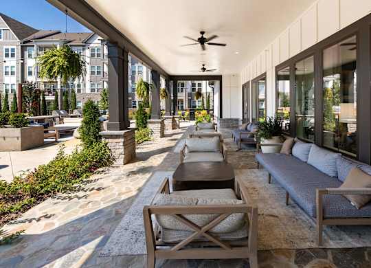 Covered Patio Featuring Outdoor Sofas and Stone Tile Flooring