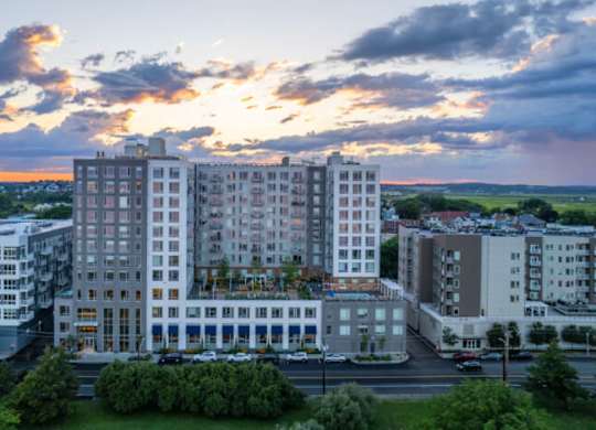 A large white building with a parking lot in front of it.