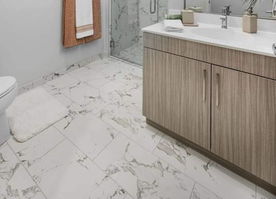 A bathroom with a toilet, sink, and a mirror.