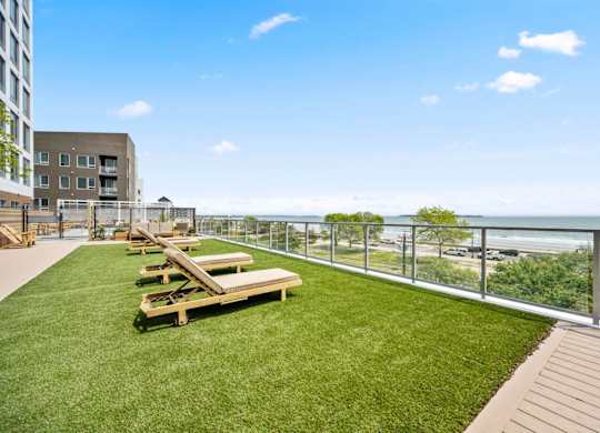 A patio with a table and chairs overlooking the ocean.