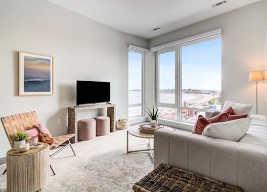 A living room with a couch, chair, and television.
