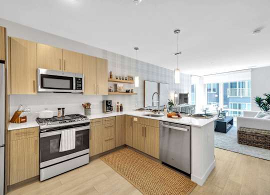 A modern kitchen with wooden cabinets and stainless steel appliances.