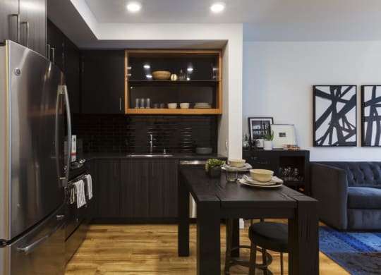a kitchen and dining area with a table and a refrigerator