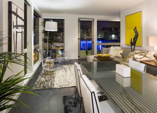 a living room and dining room with a glass table