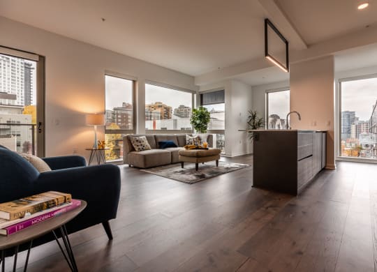 a living room with a kitchen and a view of the city