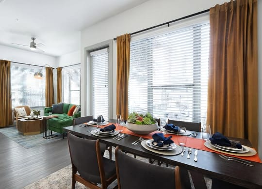 Open Dining and Living Space with Wood-Style Flooring and Ceiling Fan