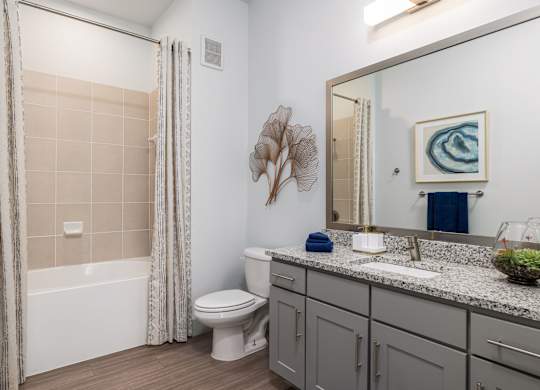 Rhythm Bathroom with Large Shower and Quartz Countertop Vanity