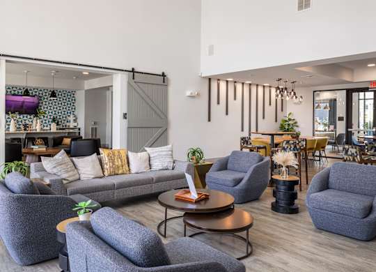 Rhythm Resident Lounge with grey chairs and a grey sofa.