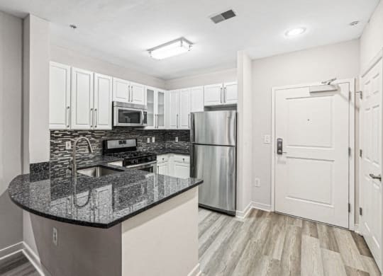 a kitchen with granite counter tops and stainless steel appliances
