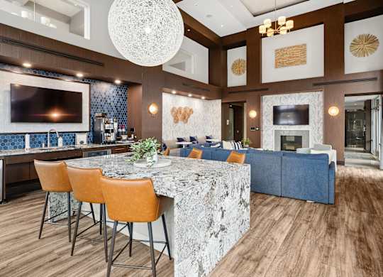 A modern kitchen with a bar area and a dining table.