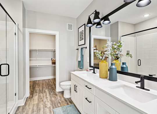 A bathroom with a white sink and a mirror.