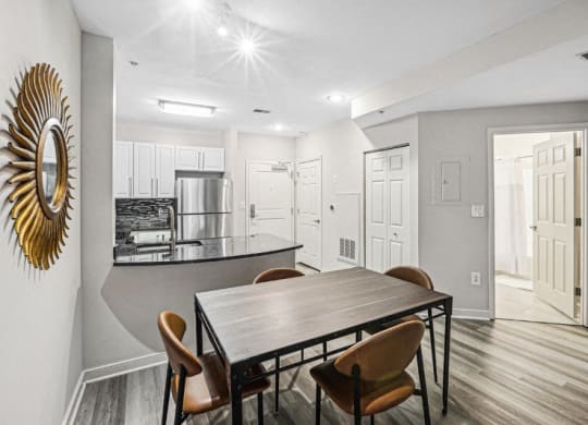 a dining room and kitchen with a table and chairs