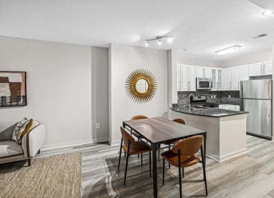 a kitchen and dining room with a table and chairs