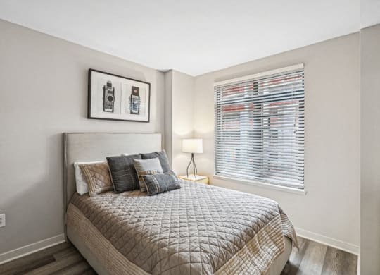 a bedroom with a bed and a window