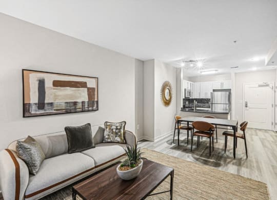 the living room of an apartment with a couch and a table