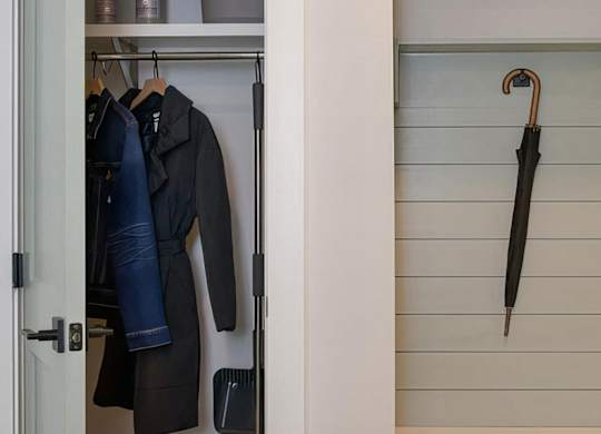 Cozy entryway foyer with hall closet and coat hooks at Novel Cary
