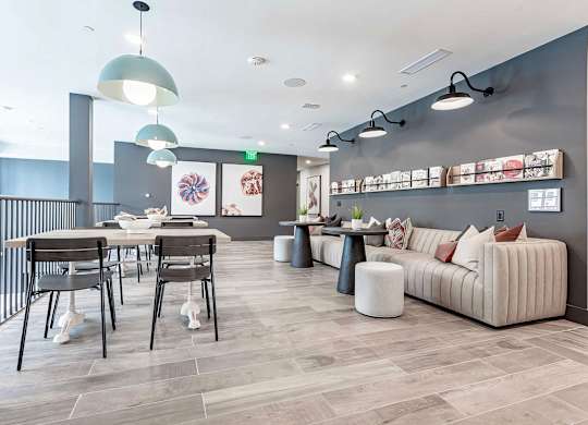 Cozy reading area with extra large sofa and magazine rack at Novel Cary