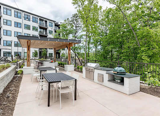 Fun and beautiful outdoor kitchen and seating areas with standard and ceramic grills at Novel Cary