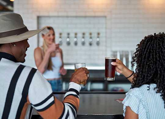 Share a laugh over drinks at a local bar near Novel Cary