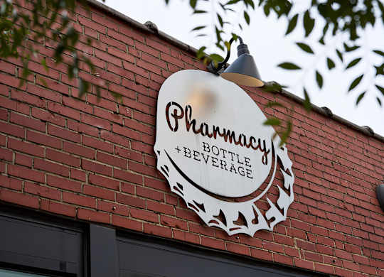 Stop by the local Pharmacy Bottle + Beverage for a drink near Novel Cary