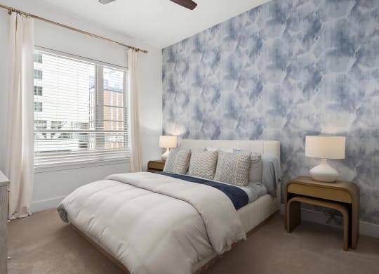 Spacious Bedroom with King Bed, Dark Accent Wall, and Elegant Lighting