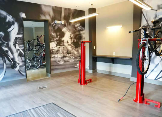 Indoor Bike Storage Room Featuring Repair Stands and Workstation