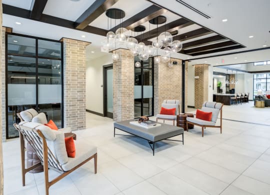 Stylish Resident Lounge with Natural Brick Columns and Pendant Lighting