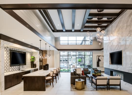 Lounge with Cozy Fireplace, High Ceilings, and Ample Natural Light