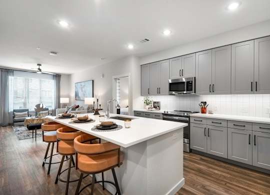 Open Concept Kitchen with Large Island, Grey Cabinets, and Bar Seating