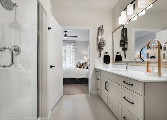 Upgraded Bathroom with Double Vanity and Frameless Walk-In Shower