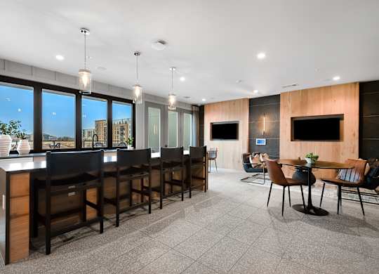 Community Workspace with Bar-Height Seating, Pendant Lights, and Lounge Areas