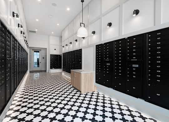 Secure Resident Mailroom with Individual Lockers and Modern Tile Flooring