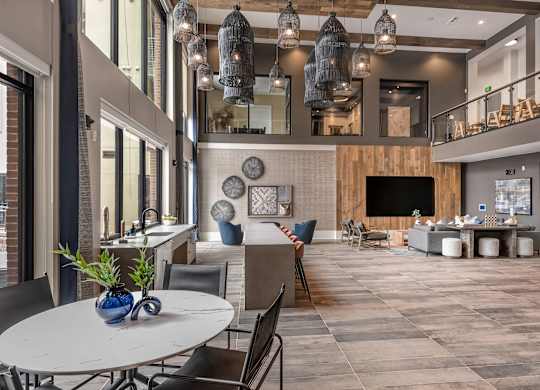 Expansive Two-Story Lounge with Pendant Lighting, Seating Areas & Floor-to-Ceiling Windows