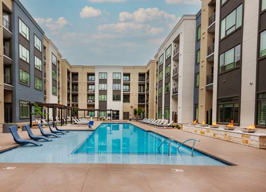 Large Swimming Pool Surrounded by Lounge Chairs