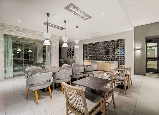Elegant indoor lounge with marble accents, designer lighting, and flexible seating for dining or entertaining