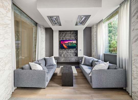 Sophisticated lounge with modern sofas, marble details, and wall-mounted TV for stylish relaxation