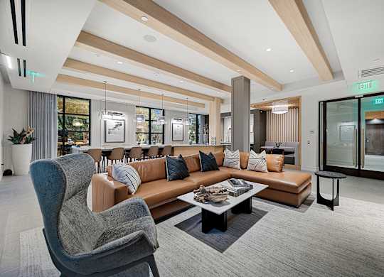 Stylish resident lounge with leather sectional, designer seating, and modern lighting for gatherings and relaxation