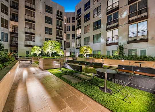 Tranquil courtyard with landscaped greenery, intimate seating, and modern design for outdoor gatherings