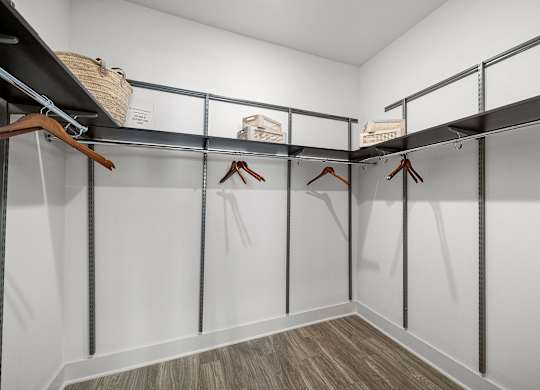 Spacious walk-in closet with built-in shelving and plenty of room for organized storage