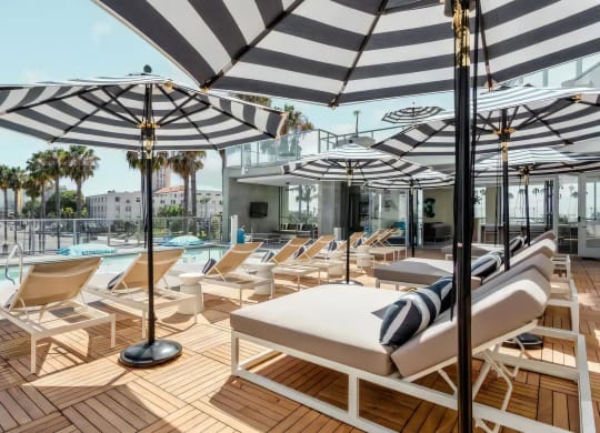 Relaxing Poolside Lounge Area with Daybeds and Outdoor Seating