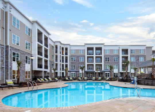 Community Pool with Expansive Sundeck and Lounge Chairs